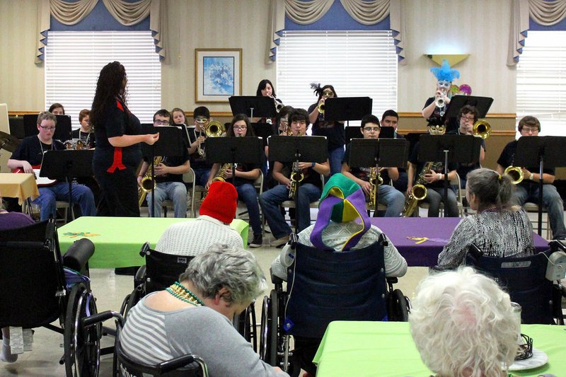 MEGAN DAVIS MCDONALD COUNTY PRESS/Residents and musicians both dressed the part of Mardi Gras attendees during the MCHS Jazz Band&#8217;s performance on Fat Tuesday. Every way you looked, there were masks, beads and bold hats.