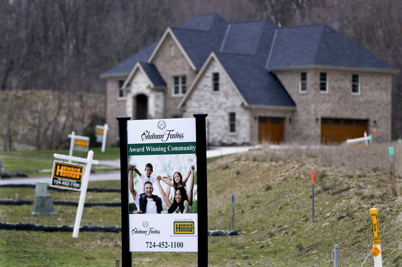 In this Monday, Feb. 27, 2017, photo, real estate signs mark the lots near one of the new homes for sale in a development for new homes in Cranberry Township, Butler County, Pa. 