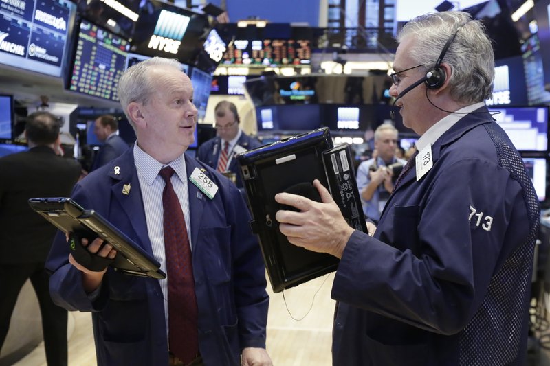 Traders James Riley, left, and Frank O'Connell work on the floor of the New York Stock Exchange, Wednesday, March 22, 2017. Stocks are treading water in early trading as gains in high-dividend stocks are outweighed by drops in banks and other sectors. (AP Photo/Richard Drew)