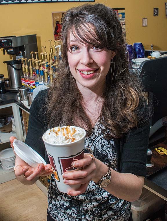 Jessica Crabtree shows off a specialty coffee drink that she made at Rock-N-Java in Clinton. Crabtree, 27, was honored as the Volunteer of the Year by the Clinton Chamber of Commerce on March 7. She is involved with the Clinton Hunger Run, which is a race to raise money for two 
Van Buren County food banks. 