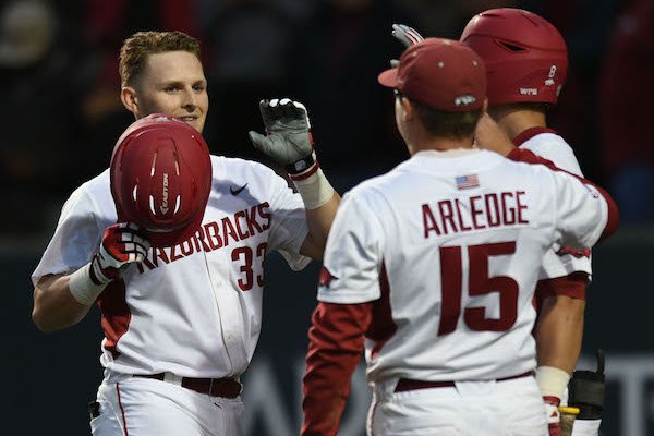 Arkansas catcher Grant Koch celebrates with center fielder Jake Arledge (15) after hitting a 2-run home run against New Orleans Wednesday, March 22, 2017, during the fifth inning at Baum Stadium.