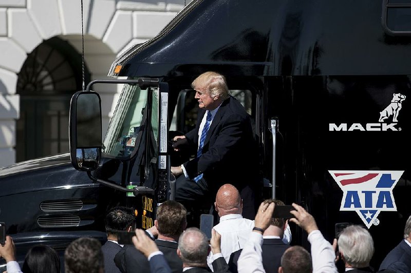President Donald Trump gets out of an 18-wheeler on the South Lawn of the White House in Washington on Thursday to meet with truckers and industry CEOs regarding health care.