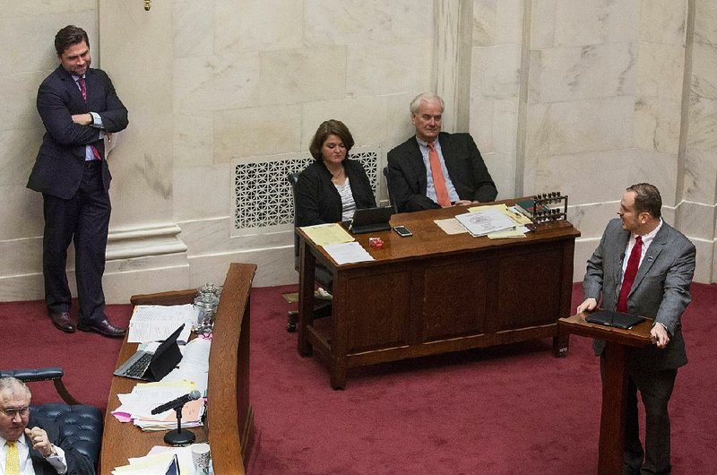 Sen. Trent Garner (right) speaks Thursday against a bill by Senate President Pro Tempore Jonathan Dismang (left). Dismang’s bill would exclude the University of Arkansas for Medical Sciences and the State Hospital from the public places where a new law will allow concealed-weapon licensees to carry their weapons after undergoing training.