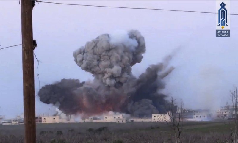 This frame grab from video provided on Wednesday March 22, 2017, by Ibaa news agency, the communications arm of the al Qaeda-linked, Levant liberation committee, outlet that is consistent with independent AP reporting, shows black smoke rising after a suicide bomber from the militant group of Levant Liberation Committee, blowup himself at a Syrian government forces position, in Souran Town, northern Hama, Syria. Insurgents advanced on government-held towns and positions north of the central city of Hama. An al-Qaida-linked group spearheaded the assault, launched Tuesday, by detonating a car bomb in the nearby town of Souran. 