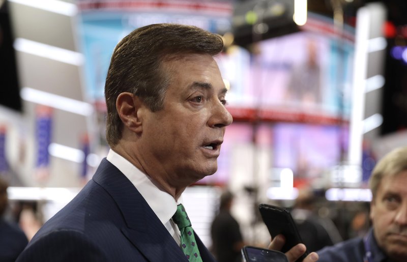 FILE - In this July 17, 2016, file photo, then-Trump campaign chairman Paul Manafort talks to reporters on the floor of the Republican National Convention in Cleveland. U.S. Treasury Department agents have recently obtained information about offshore financial transactions involving Manafort, as part of a federal anti-corruption probe into his work in Eastern Europe, The Associated Press has learned. (AP Photo/Matt Rourke, File)