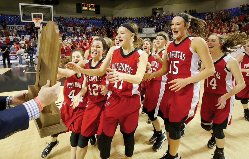 Pocahontas players, led by Anna Baltz, No. 12; Ashlyn Ellis, No. 11; and Kristen Wiseman, No. 15, run to the Class 4A State Championship trophy after their overtime win over Pottsville at the Bank of the Ozarks Arena in Hot Springs on March 11.