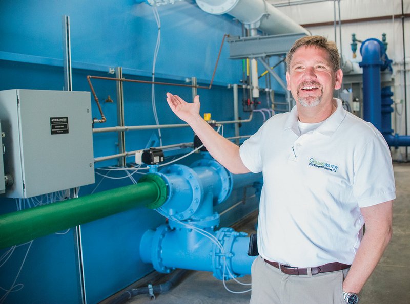 Heath Vaughan of Salado in Independence County, owner of ClearWater Utility Management Services, discusses the new water-treatment plant in Tuckerman. The plant features this Tonka Water filtration system, which processes 800 gallons of water a minute and is fully enclosed in a 4,500-square-foot engineered metal building that was constructed on-site. The city owns the water-treatment plant, but it is managed by Vaughan, who can monitor and operate it remotely through his cellphone if he is not on-site.