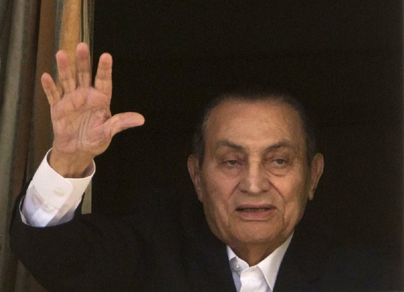 In this Monday, April 25, 2016 file photo, ousted Egyptian President Hosni Mubarak waves to his supporters from his room at the Maadi Military Hospital in Cairo, Egypt.