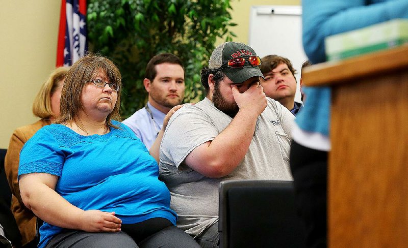 Melissa Cassidy (left) comforts her nephew, Jonathan Erickson, during testimony about death-row inmate Stacey Johnson at a Parole Board hearing Friday in Little Rock. Johnson killed Carol Heath, Cassidy’s sister and Erickson’s mother, in 1993.
