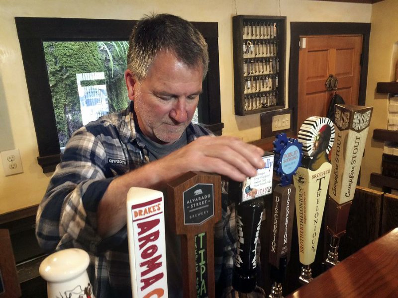 Big Sur Taproom and Deli owner Kurt Mayer pours a beer in Big Sur, Calif. earlier this month.