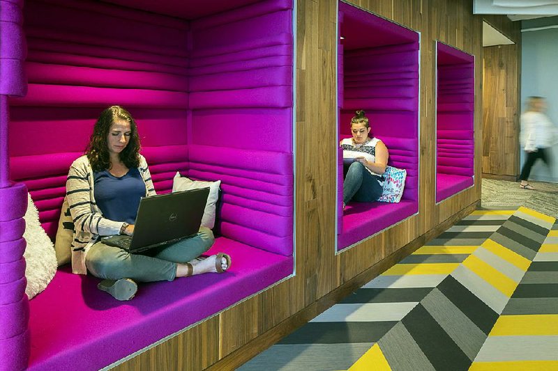 Jen Taylor and Michelle Bristol of Dyer Brown, an architectural firm, are seated in workspaces they designed for the Boston offices of Criteo, a tech company.

