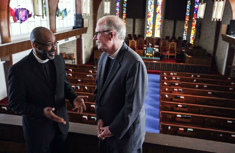 The Rev. Roy Jones (left), pastor of Bethel African Methodist Episcopal Church and the Rev. Chris Keller, dean and rector of Trinity Episcopal Cathedral have a conversation in the Bethel sanctuary. The two congregations have had a covenant for years and are working to deepen their relationship.