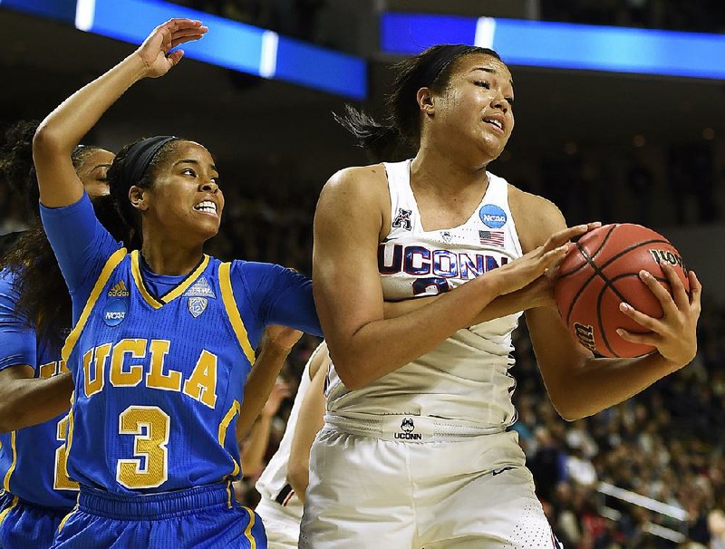 Connecticut’s Napheesa Collier (right) grabs one of her 14 rebounds in Saturday’s Bridgeport Regional semifinal game against UCLA. Collier had 27 points in the Huskies’ victory.