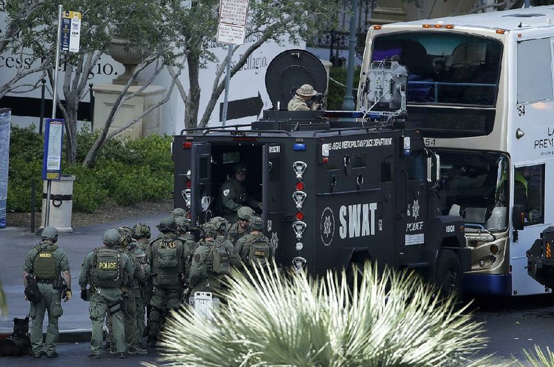 Special weapons and tactics police officers surround a bus during Saturday’s standoff on the Las Vegas Strip.
