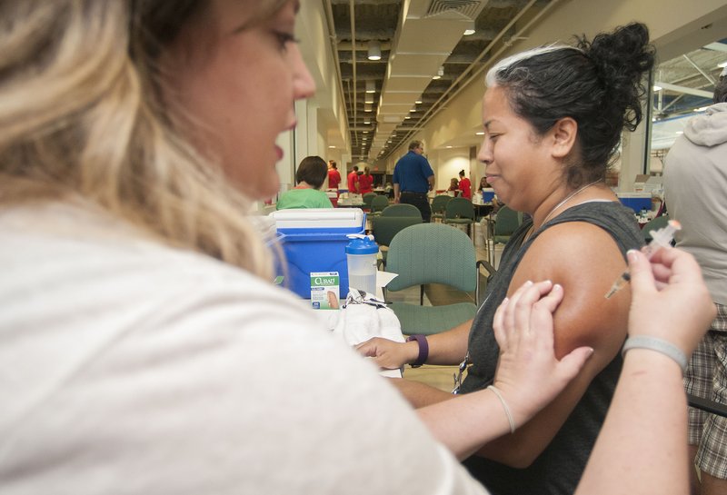 NWA Democrat-Gazette/File photo A woman gets a measles-mumps-rubella vaccine shot at the Jones Center in Springdale last September.