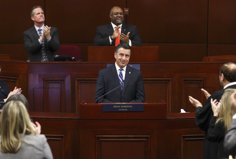 In this Tuesday, Jan. 17, 2017 file photo, Gov. Brian Sandoval receives a standing ovation at the conclusion of his state of the state address at the Legislative Building in Carson City, Nev. 
