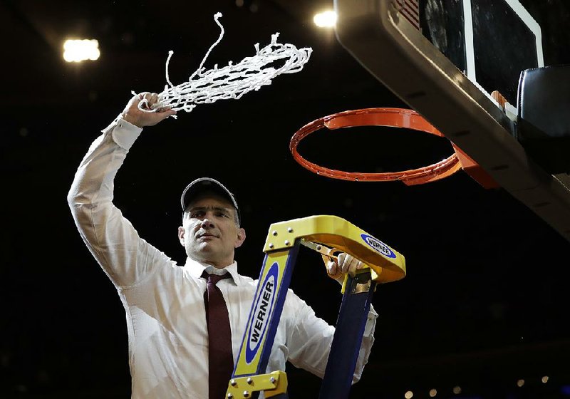 South Carolina Coach Frank Martin cuts down the net after the Gamecocks beat SEC rival Florida 77-70 to win the East Regional of the NCAA Tournament on Sunday at Madison Square Garden in New York and advance to the Final Four for the first time.