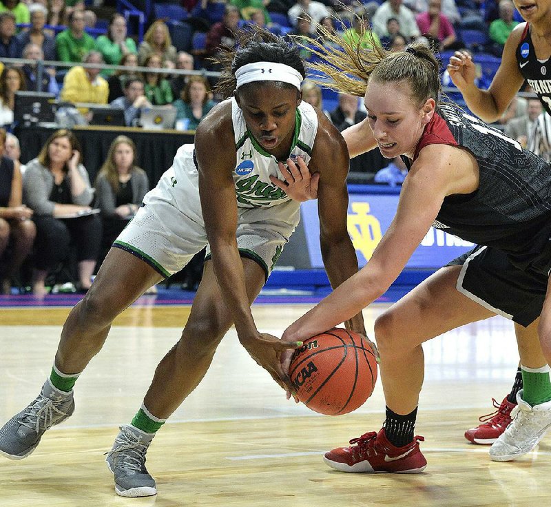 Stanford’s Alanna Smith (right) battles with Notre Dame’s Jackie Young for a loose ball in the Lexington Regional final of the NCAA women’s basketball tournament. Smith later hit the game-winning shop with 23 seconds left to give the Cardinal a 76-75 victory.