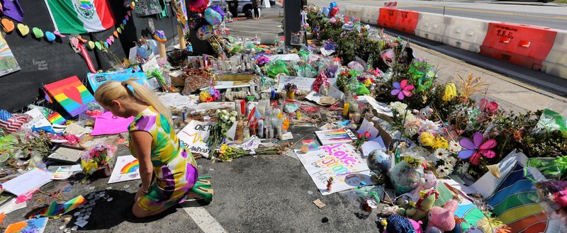 FILE - In a Monday, July 11, 2016 file photo, visitors continue to flock to the Pulse nightclub to their pay their respects, in Orlando,, Fla. 