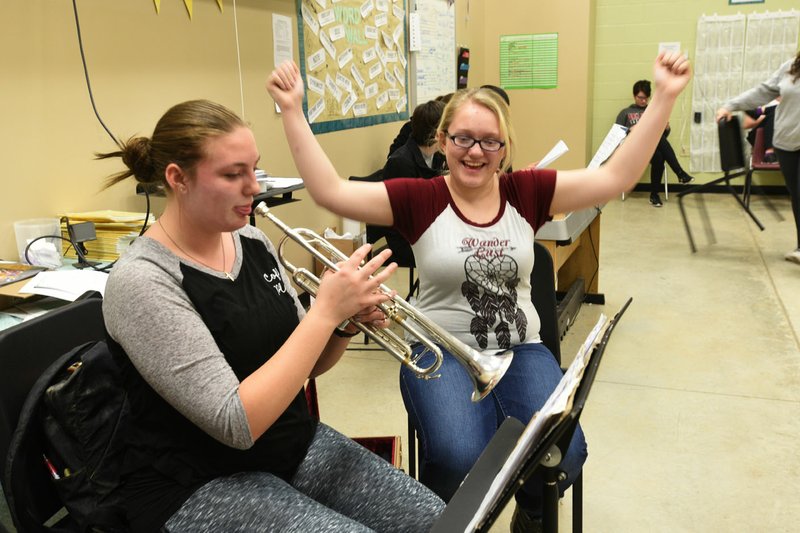 Corra Wilson (left) and Hailey Key work on a music lesson March 15 2017 at Pea Ridge High School. The district will ask voters to approve an additional 5.1 mills to build a new high school.
