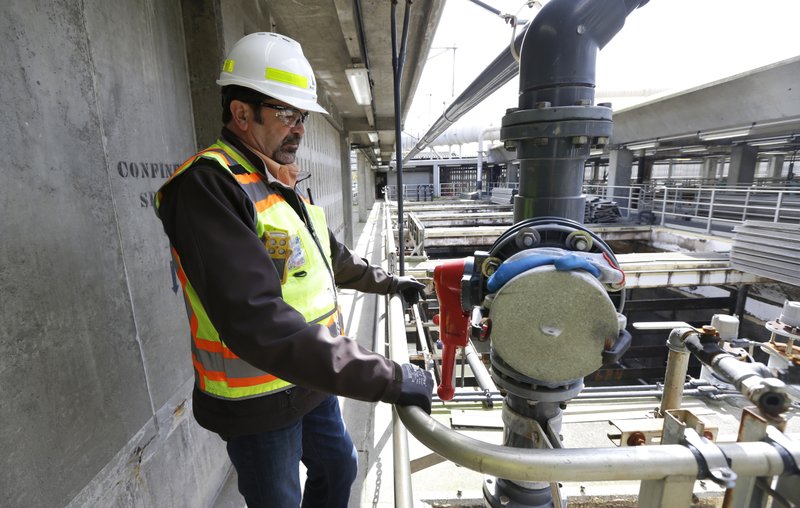 In this March 16, 2017 photo, Robert Waddle, division operations manager at the West Point Treatment Plant in Seattle, stands near a closed valve next to empty pools normally used to remove grit and other solids from sewage and storm water. The plant is still recovering from an equipment failure that crippled operations and caused millions of gallons of raw sewage and untreated runoff to pour into the United States' second largest estuary. 