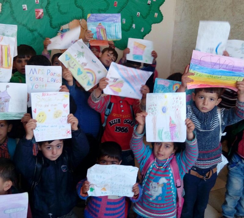 Submitted photo LETTERS OF HOPE: Syrian children with the Wisdom House Project in the Idlib Governorate display the first batch of letters sent to them from American students. The school is supported entirely by donations to the Syrian Emergency Task Force.