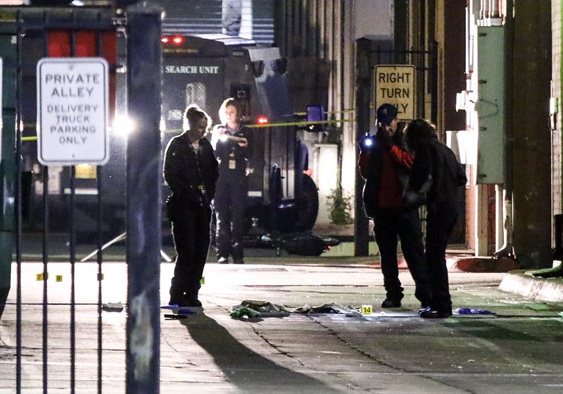 Police investigate the scene of a fatal officer-involved shooting early the morning of March 26, 2017, in an alley in Little Rock's River Market District.