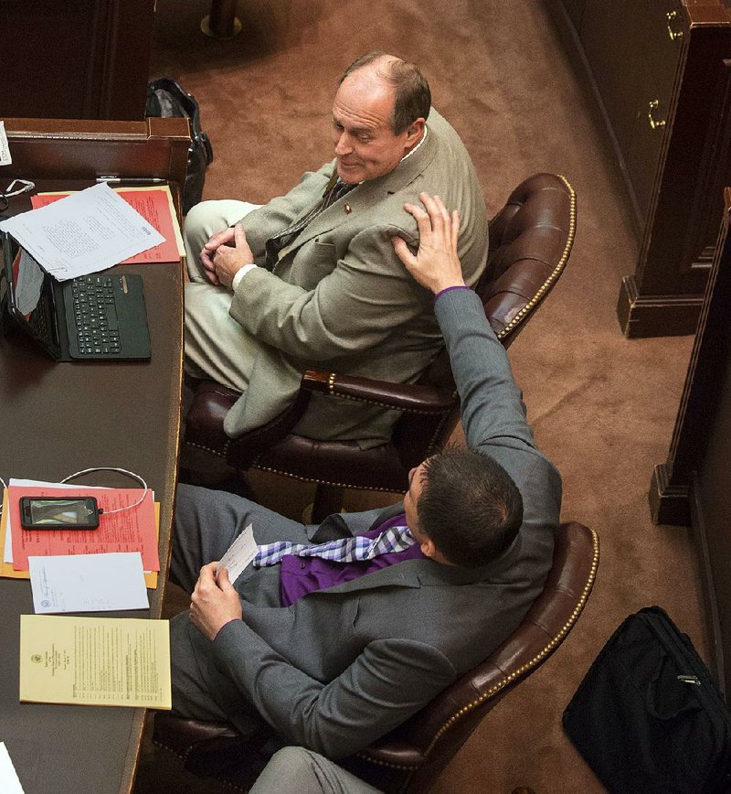 Rep. Clint Penzo, R-Springdale (bottom), consoles Rep. Johnny Rye, R-Trumann, after Rye’s bill failed to pass by two votes Monday afternoon in the House. However, Monday evening, the House voted again and approved the bill to use a portion of sales tax collected from online purchases for highway funding.
