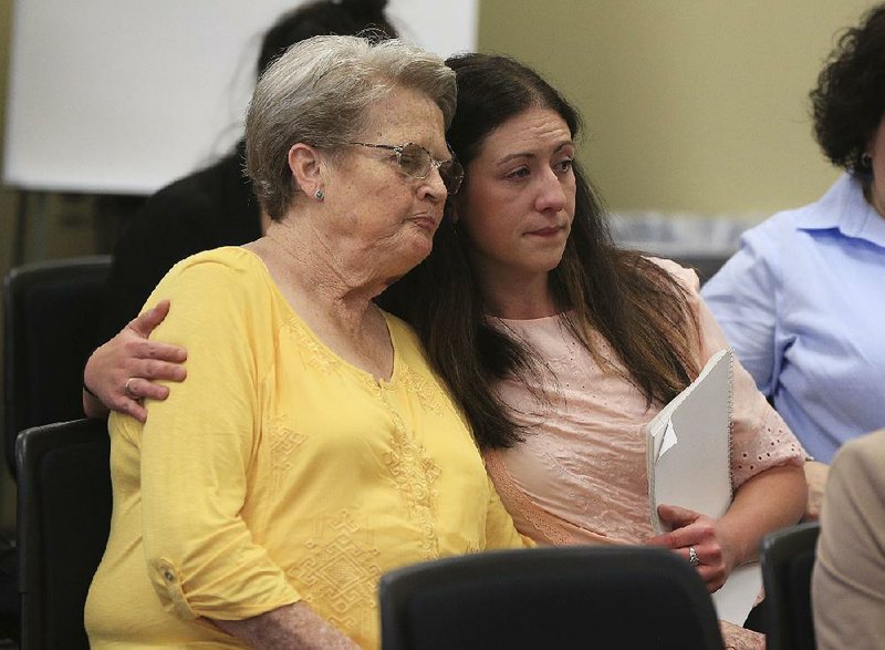 Trista Wussick (right) puts her arm around Carolyn Moore on Monday after both spoke at a clemency hearing for Marcell Williams, who is scheduled to be put to death April 24 for raping and killing Stacy Errickson. Moore, Errickson’s mother, and Wussick, Errickson’s friend, spoke against clemency for Williams.