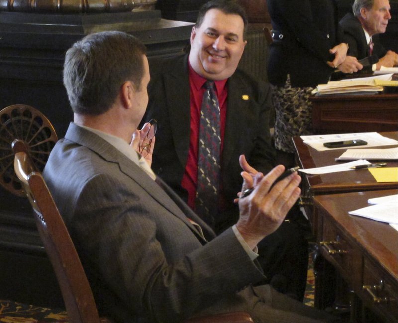 Kansas state Sen. Rob Olson, right, R-Olathe, confers with Sen. Dennis Pyle, left, R-Hiawatha, during the Senate's debate on a bill expanding the state's Medicaid program, Monday, March 27, 2017, at the Statehouse in Topeka, Kan. 