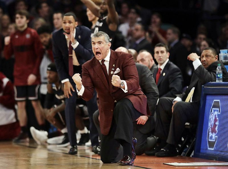 In this Sunday, March 26, 2017, file photo, South Carolina head coach Frank Martin reacts during the second half of the East Regional championship game against Florida at the NCAA men's college basketball tournament in New York. 