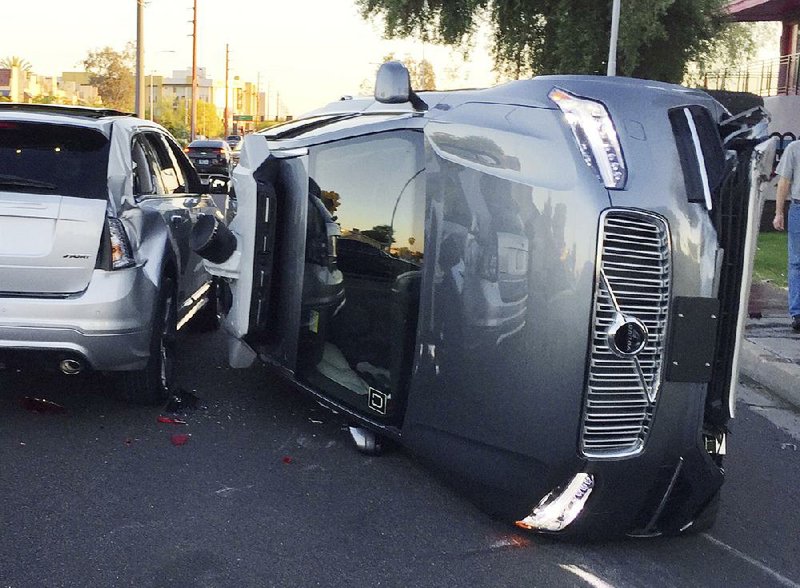 An Uber self-driving SUV is rolled onto its side after a collision in Tempe., Ariz., on Friday in this photo provided by the Tempe Police Department. 