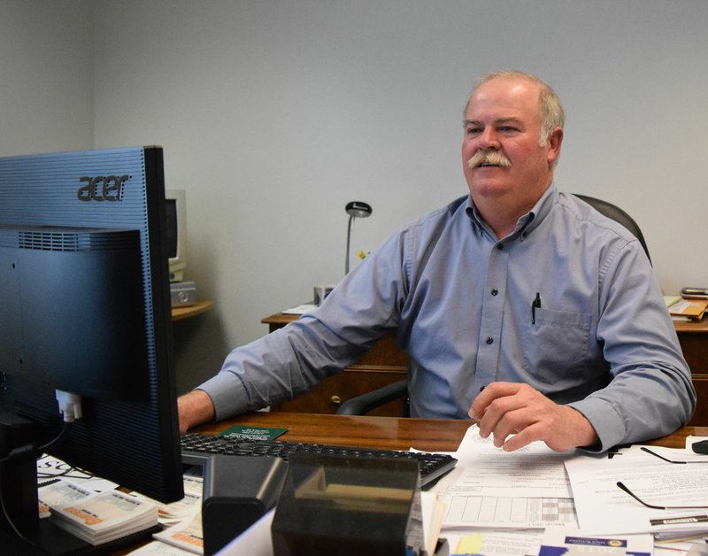 Photo by Mike Eckels Terry Luker, Decatur police chief, looks up information on his crime database March 16. Luker is retiring from the police force after 28 years of service in the Benton County Sheriffs Office and Gravette and Decatur Police Departments.