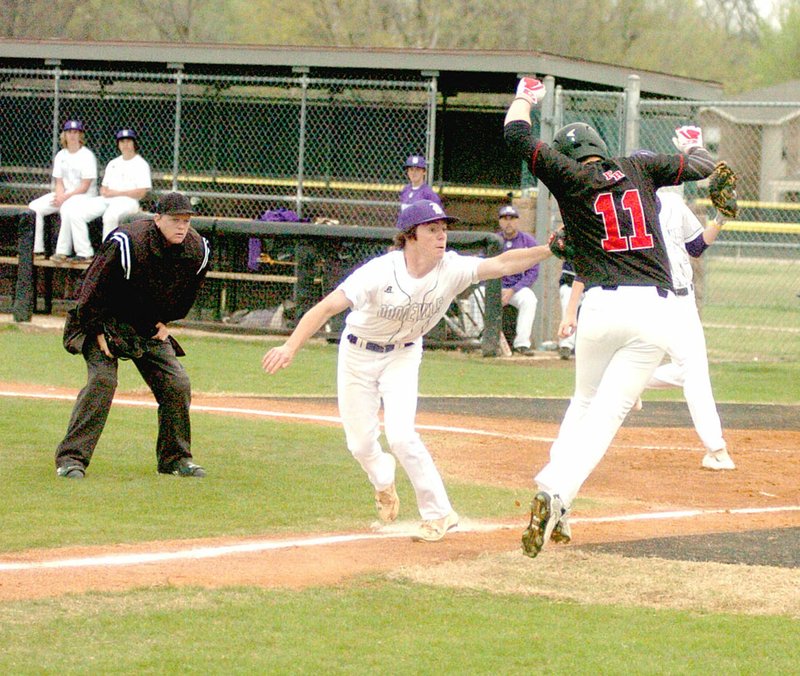 MARK HUMPHREY ENTERPRISE-LEADER/Pea Ridge senior Westin Church tries to avoid a tag by Booneville senior Hayden Fennell during a rundown at the first Jarren Sorters Memorial Baseball Tournament held last week at Prairie Grove's Rieff Park. He was out on the play, but the Blackhawks edged the Bearcats, 8-7, on March 22.