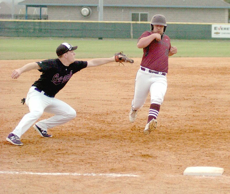 Photo by Mark Humphrey/Enterprise-Leader Gentry&#8217;s Myles McFerron dodges an attempted tag before sliding into third base. The Pioneers competed in the Jarren Sorters Memorial Baseball Tournament at Prairie Grove March 21, losing to Ozark, 15-2.