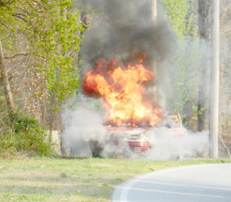 Photo by Janet Walton A car caught fire on Euston Road near the Metfield Golf Course on March 22. There was just smoke and all of a sudden the windows were popping out,&#8217; said Janet Walton, who saw the blaze and snapped this photo. Firefighters responded at 5:31 p.m. Capt. Gairy Osburn said that the Pontiac Grand Am was driving as usual and black smoke started pouring from under the hood. The driver pulled over and in moments the front end was engulfed in flames. Nobody was injured.