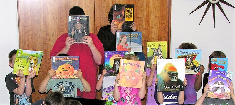 Photo by Burt Crume Several children participated in the Bookface Contest at Gentry Public Library on Thursday. Each child selected a book to use as a mask, and the masks were judged on creativity. &#8220;The Way I Feel&#8221; mask won a library book bag and several workbooks.