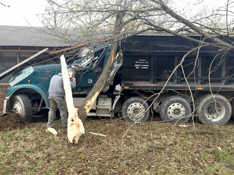 Submitted Photo This loaded dump truck did extensive damage to the front of a home at 503 Atlanta Street in Gravette Wednesday, March 22, when the driver suffered a medical emergency and lost consciousness while driving. The truck first hit a tree, then plowed into a bedroom at the front of the house before stopping at the front door.