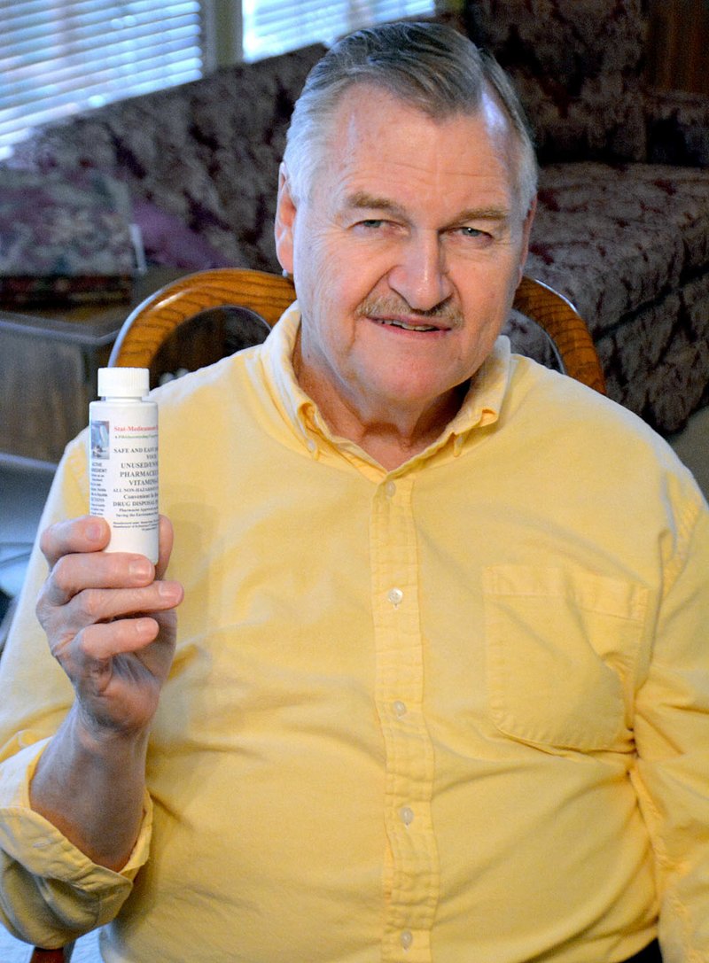Janelle Jessen/Herald-Leader Larry Kenemore, CEO of Stat-Medicament-Disposal Corporation, held up the patented bottle he developed to safely dispose of used pharmaceuticals. Kenemore&#8217;s business was recently named a winner of the 2017 American Small Business Championship, hosted by SCORE and supported by Sam&#8217;s Club.