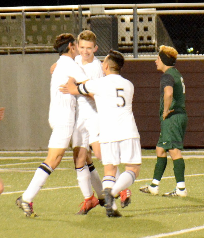 Graham Thomas/Herald-Leader Siloam Springs soccer players, from left, Christian Marroquin, Eli Jackson and Jose Serrana celebrate after Jackson scored a goal just more than a minute into Monday&#8217;s match against Muskogee, Okla. The Panthers defeated the Roughers 3-1 at Panther Stadium.