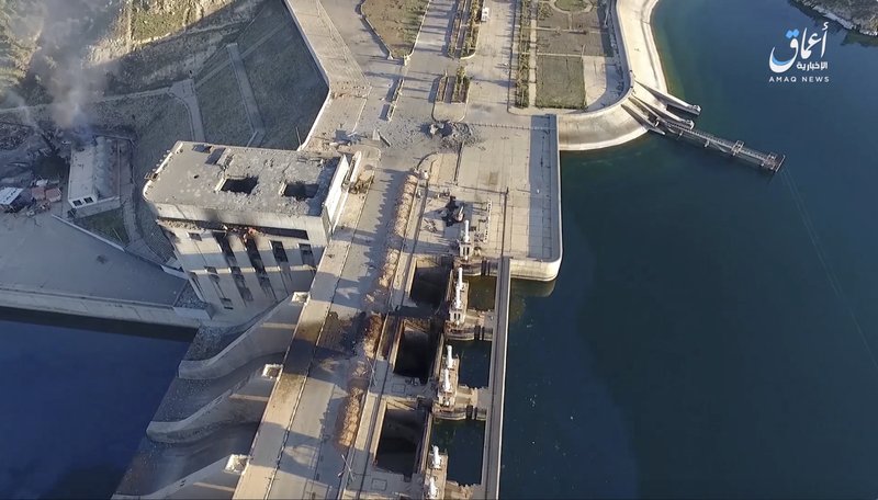 This still image taken from drone footage posted online Monday, March. 27, 2017 by the Aamaq News Agency, a media arm of the Islamic State group, shows the Tabqa Dam, in Raqqa, Syria. U.S.-backed forces in northern Syria said Monday paused military operations near a major dam held by the Islamic State group in order to allow engineers to fix any problems after conflicting reports about its stability. (Aamaq News Agency via AP)