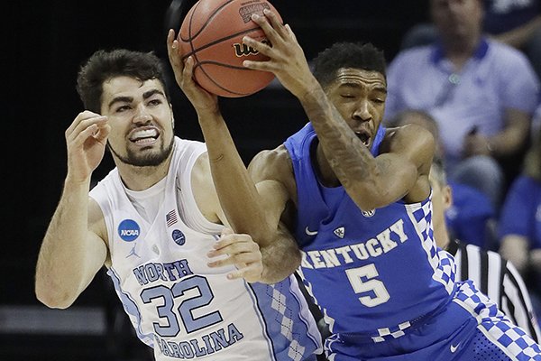 Kentucky guard Malik Monk (5) grabs a loose ball in front of North Carolina forward Luke Maye (32) in the first half of the South Regional final game in the NCAA college basketball tournament Sunday, March 26, 2017, in Memphis, Tenn. (AP Photo/Mark Humphrey)

