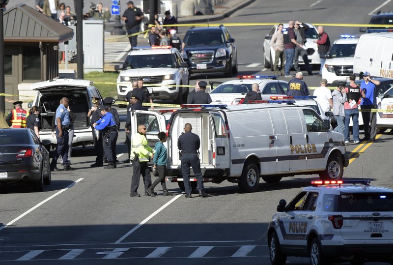 A woman, center, is taken into custody on Capitol Hill in Washington, Wednesday, March 29, 2017. Police say a driver struck a U.S. Capitol Police cruiser near the U.S. Capitol and was taken into custody. (AP Photo/Susan Walsh)
