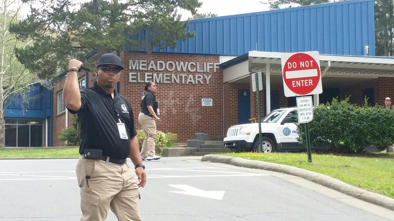 Little Rock police search Meadowcliff Elementary School while the school was locked down after two men with shotguns were reported seen on the property Wednesday, March 29, 2017.