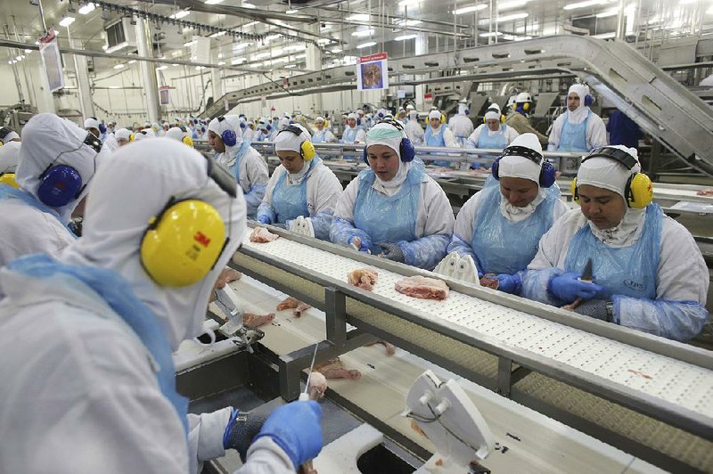 Workers prep poultry at a meatpacking plant in the Brazilian state of Parana earlier this month. Federal police in Parana announced an investigation on March 17 claiming companies were bribing federal meat inspectors. 