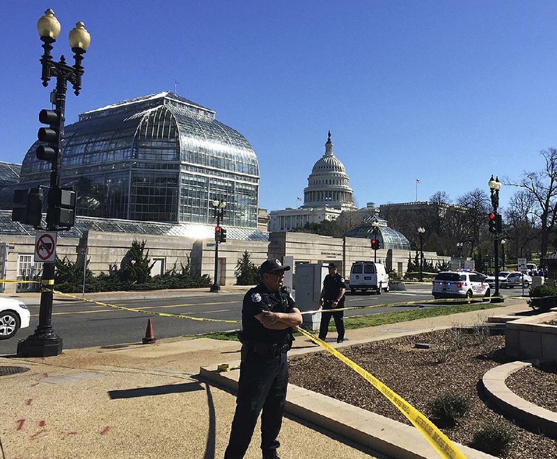 Capitol Police officers stand guard at the U.S. Botanic Garden after an incident near there Wednesday in which shots were fired.  