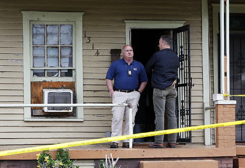 Little Rock police detectives stand at the scene Wednesday morning of an overnight homicide at 1314 W. 19th St. The city has had 15 homicides so far in 2017. 