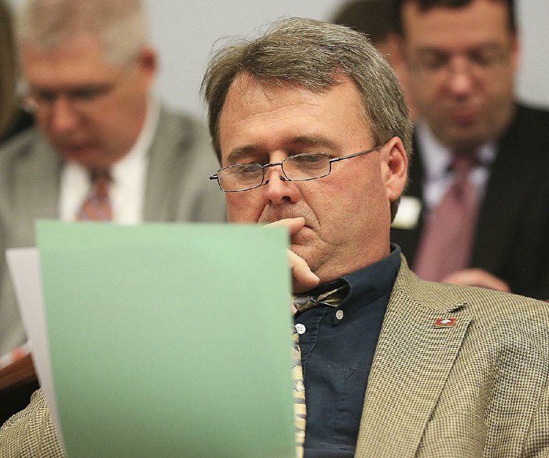Sen. Blake Johnson looks over a measure Wednesday during the Senate Education Committee meeting. 