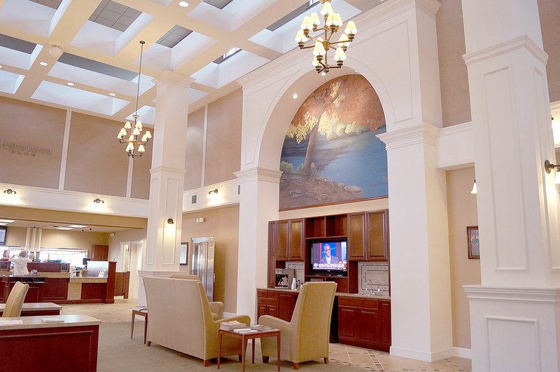 The design-award winning lobby of the Hometown Bank in Pineville. At the center is a mural painted using a photograph taken by local art teacher Holly Huber. There are photographs taken by local photographers throughout the bank.