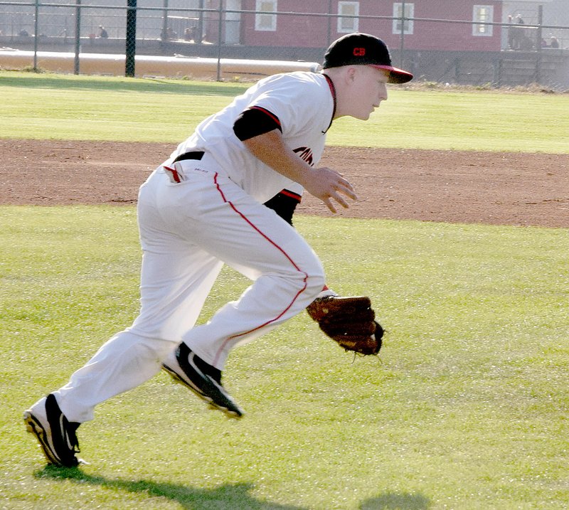 Photo by Rick Peck McDonald County third baseman Emmanuel Baisch fields a show roller to throw out a Neosho hitter during the Mustangs&#8217; 2-1 loss on March 23 at MCHS.